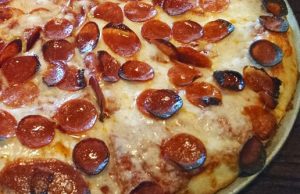 Buffalo style pizza has a soft chewy crust, a solid layer of cheese and fresh toppings.